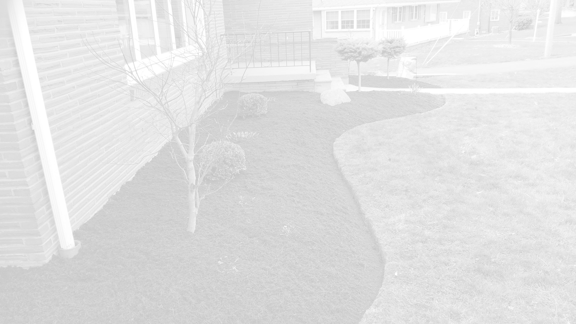 Landscaping bed in front of a home that we recently laid new black mulch.