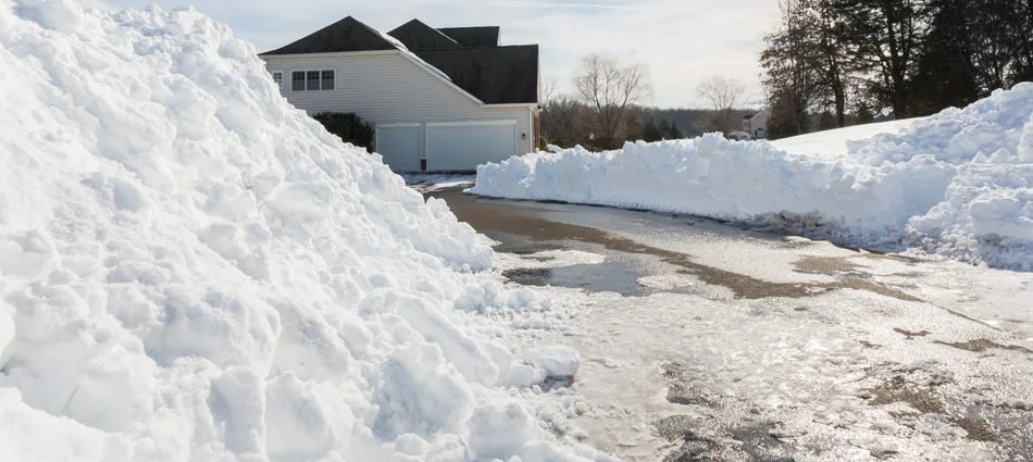Snow piled on the sides of a driveway after we plowed in Washington, PA.